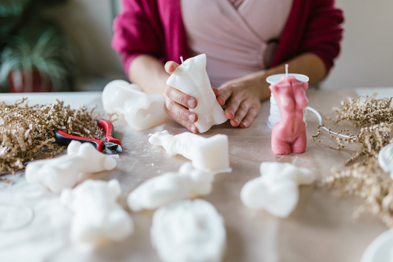 Hands crafting unique decorative candles, perfect for small business and entrepreneurship creativity.